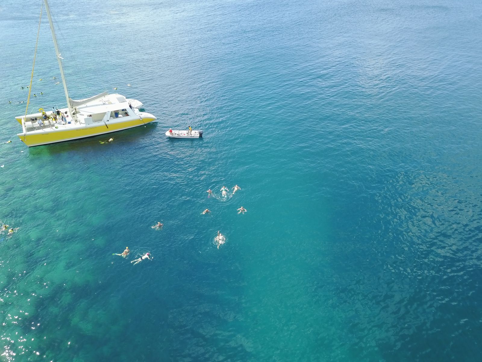 Swimming Holidays St Kitts and Nevis swimmers and boat.JPG