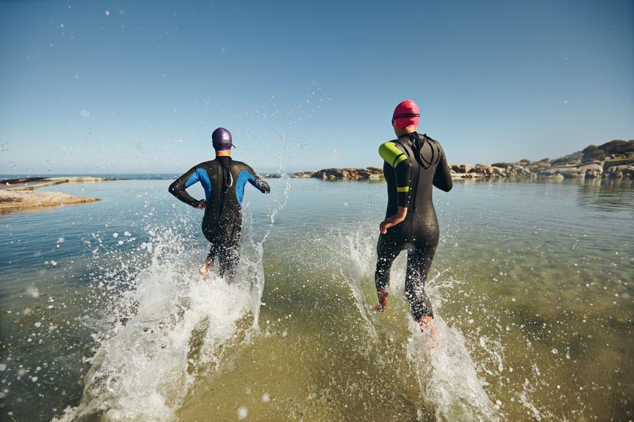 triathletes entering water